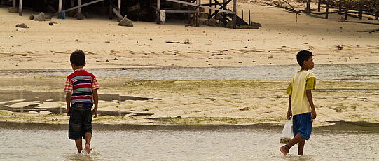 Two children on a sandy beach.