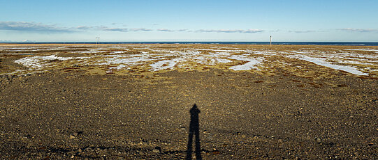 Beach panorama with shadow of the photographer.