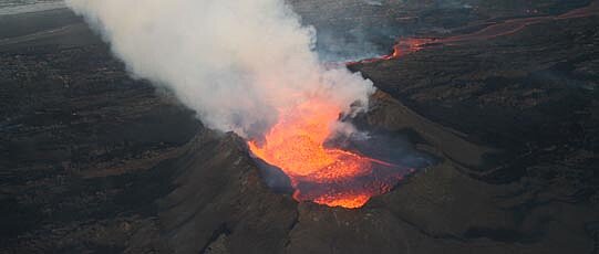 Erupting volcano with ash cloud and lava.