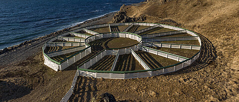 Circular animal enclosure by the sea.